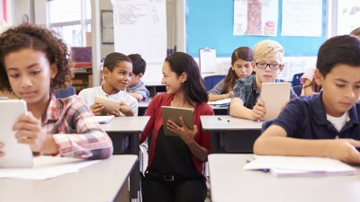 Teacher and students using ipads in the classroom