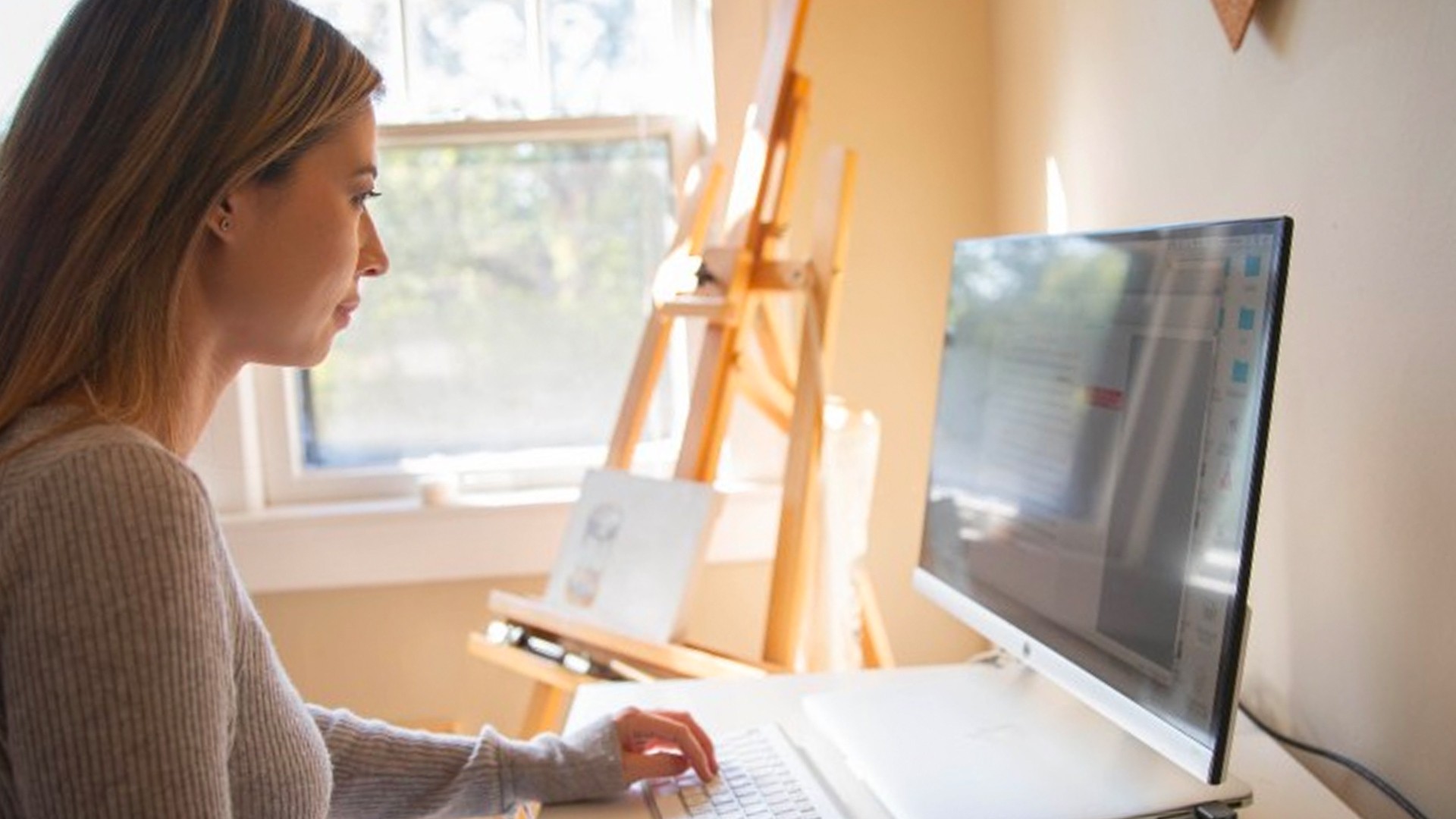 Woman using a desktop computer at home