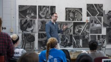 A master's in art education graduate delivers a lesson to his class - one example of a masters in art education job.