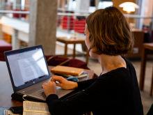 A student prepares for her online exams in a library setting.
