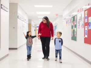 School Nurse in hallway with two children