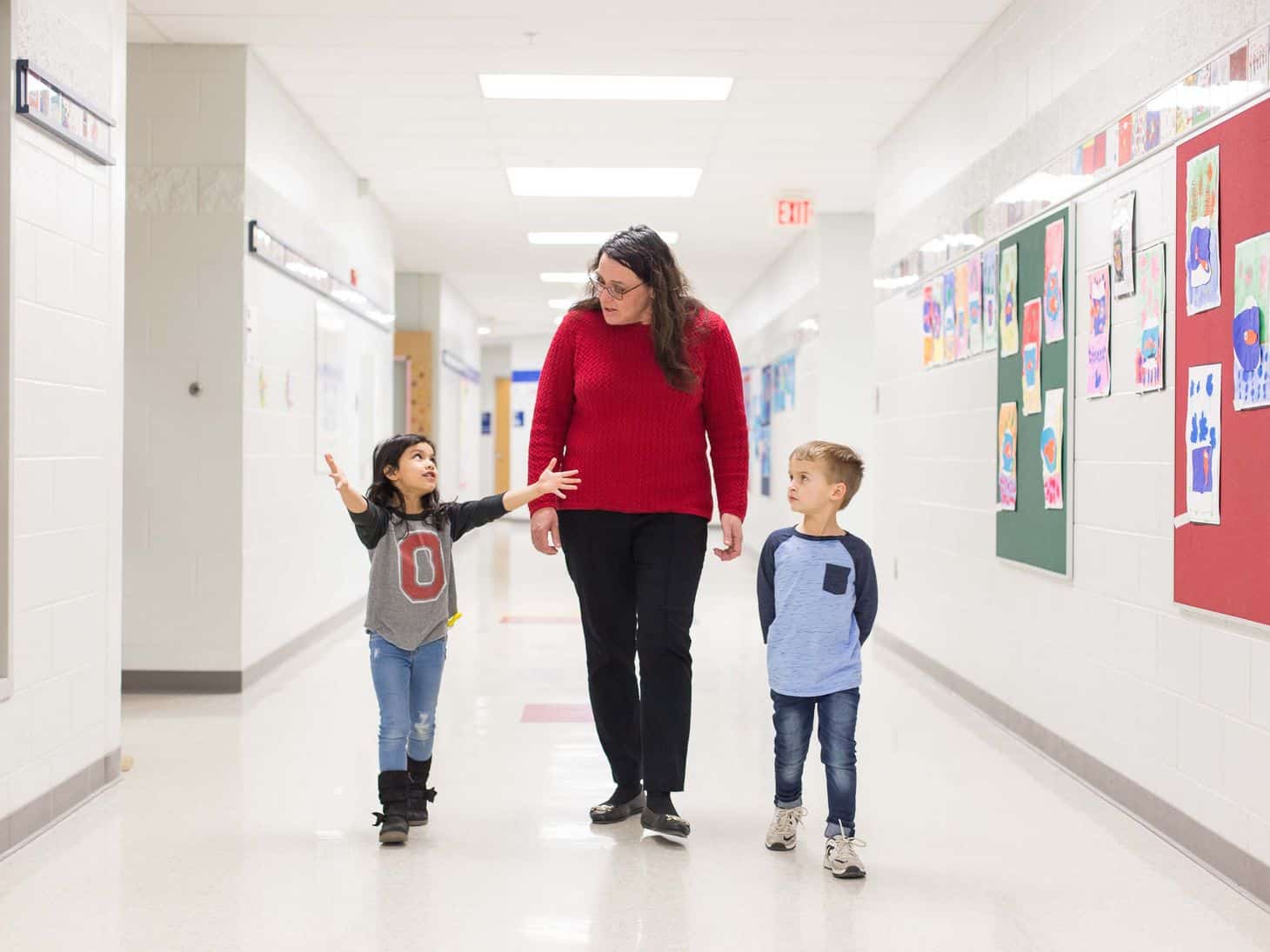School Nurse in hallway with two children