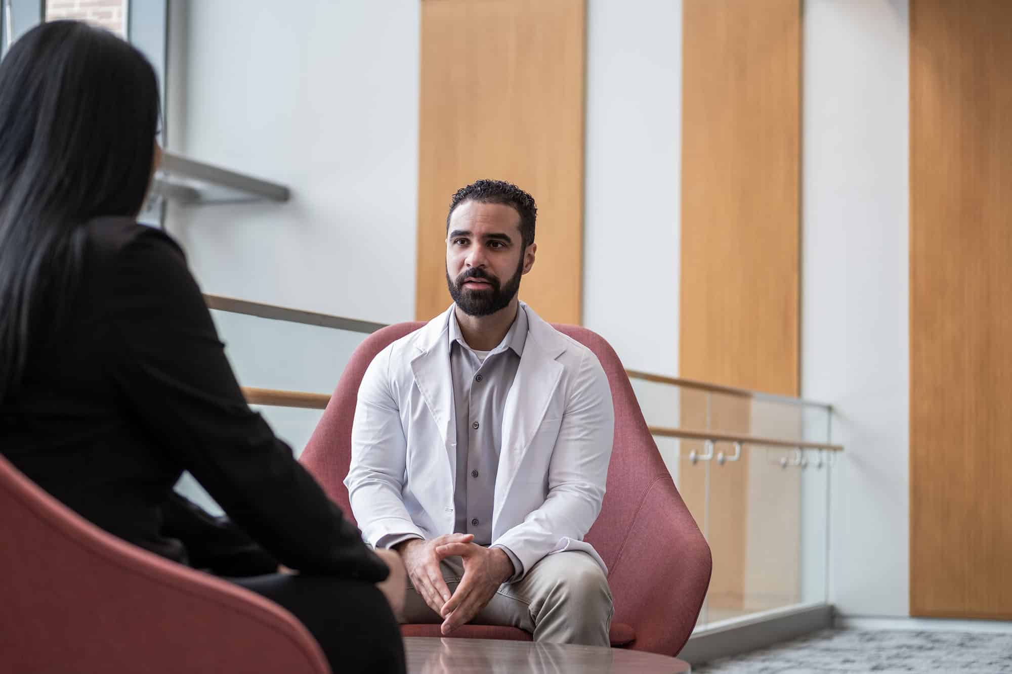 Psychiatric mental health nurse practitioner listens to patient.