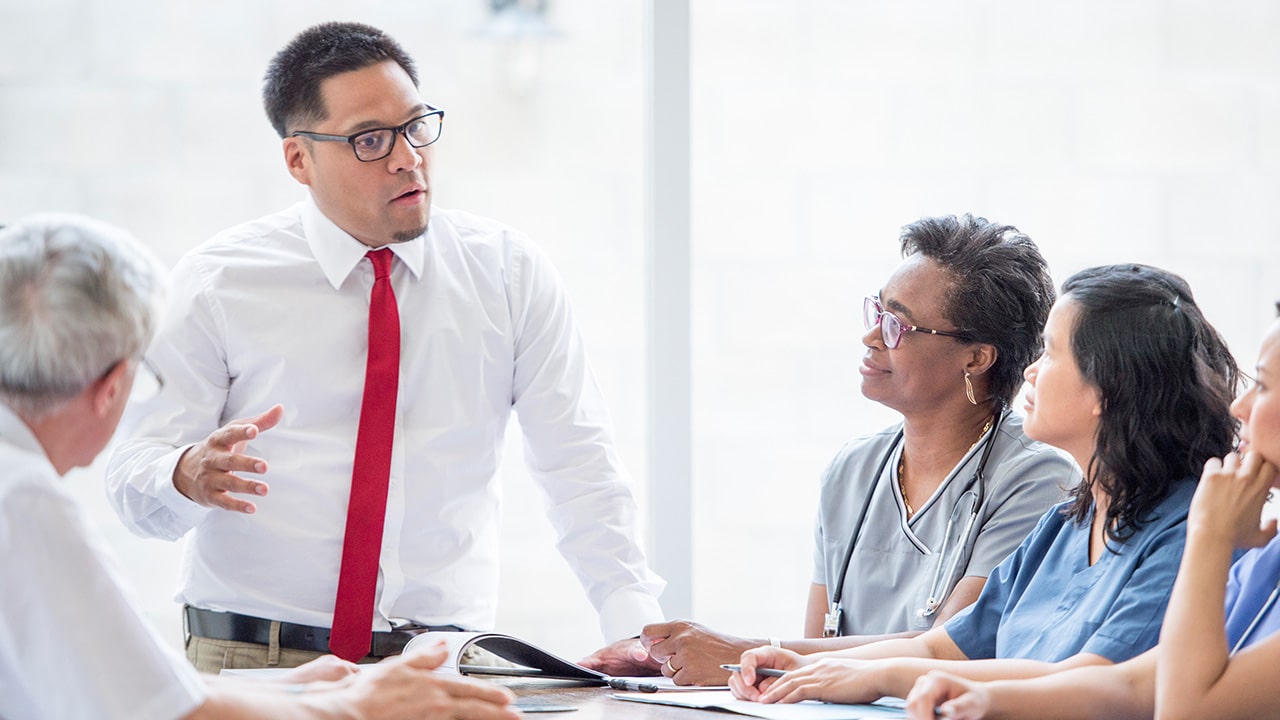 A graduate of the Ohio State Healthcare Leadership and Innovation Certificate program leads a meeting at his healthcare organization.