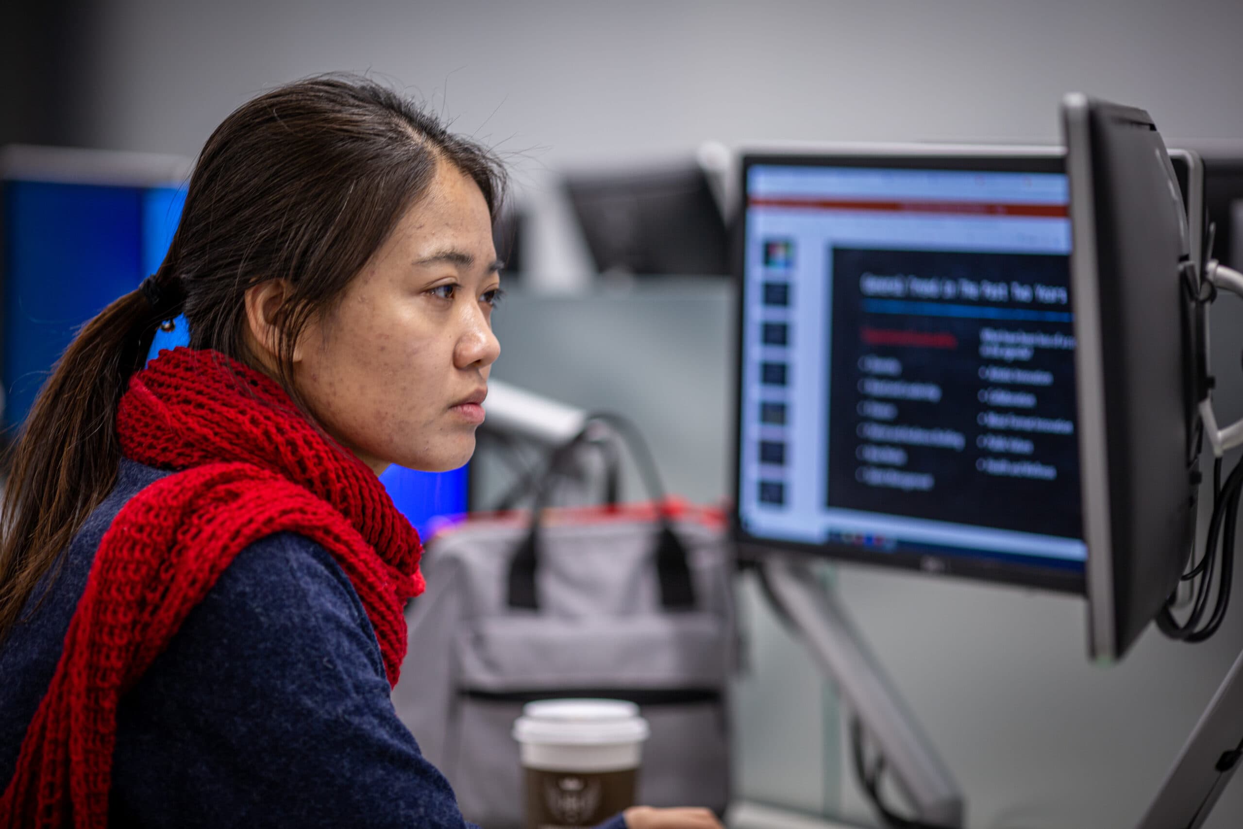 Woman sitting at computer analyzing data.