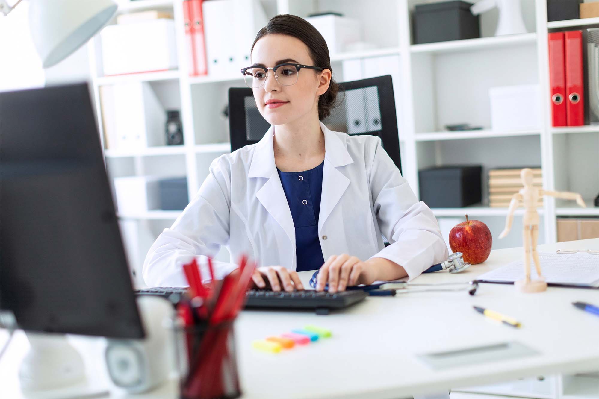 Nurse practitioner in a white coat works in office as a nurse executive