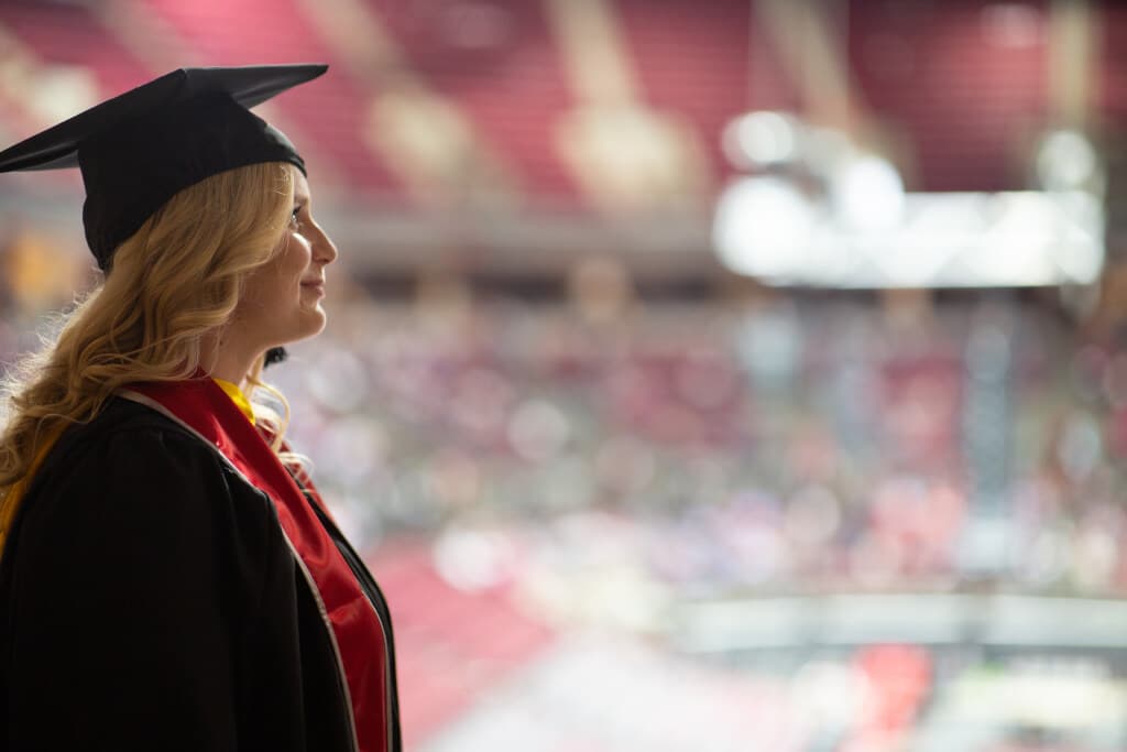 An Ohio State Graduate looking into the distance.