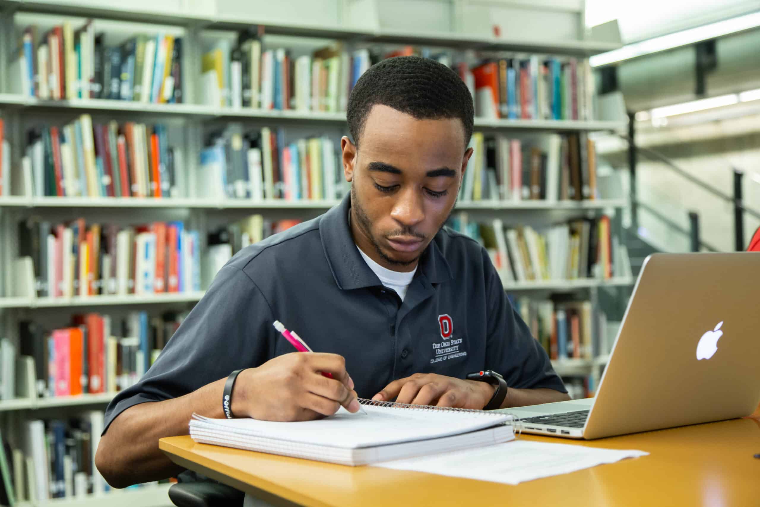 Ohio State student studying in a library.
