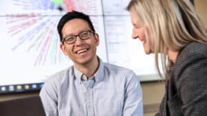 Biostatistics student smiles at fellow student