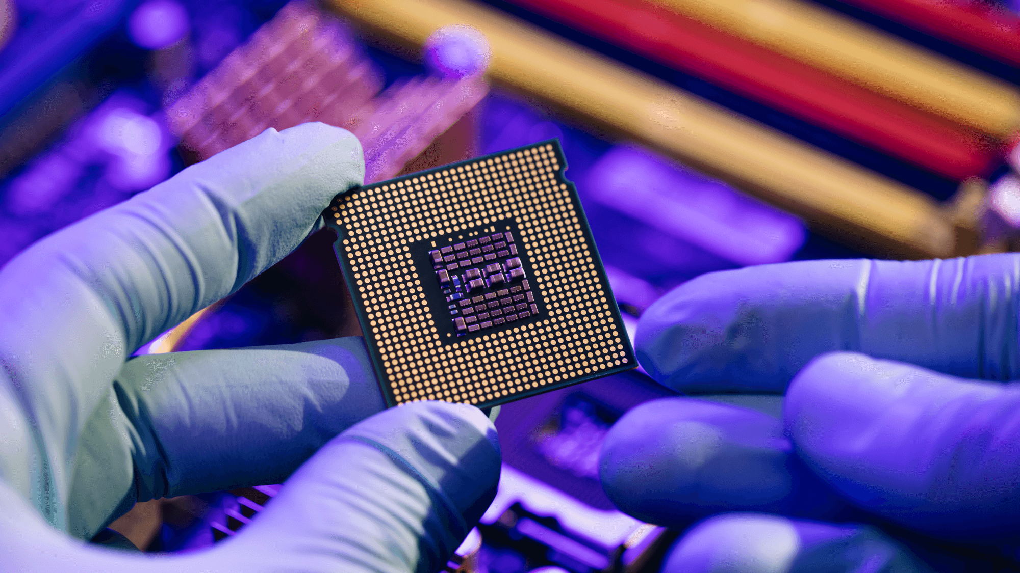 A cybersecurity student who completed the Cybersecurity Design and Implementation Certificate at Ohio State holds a computer microchip.