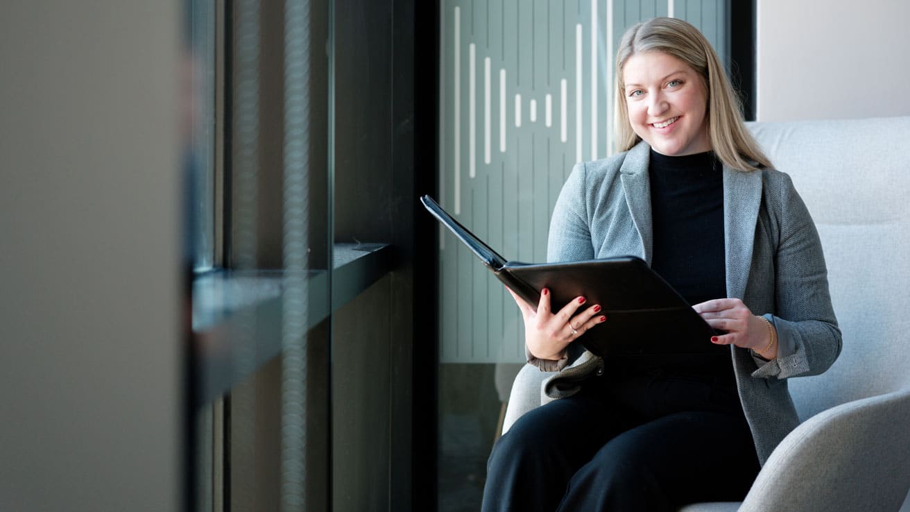 AnnaBell , MPAL alum, holding a padfolio.