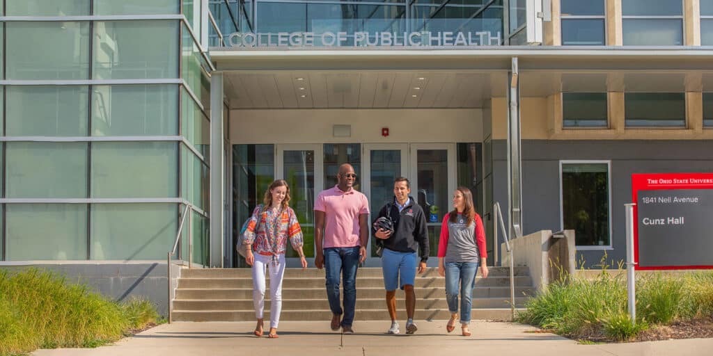 Four students walk outside of Cunz Hall, home to The Ohio State University College of Public Health