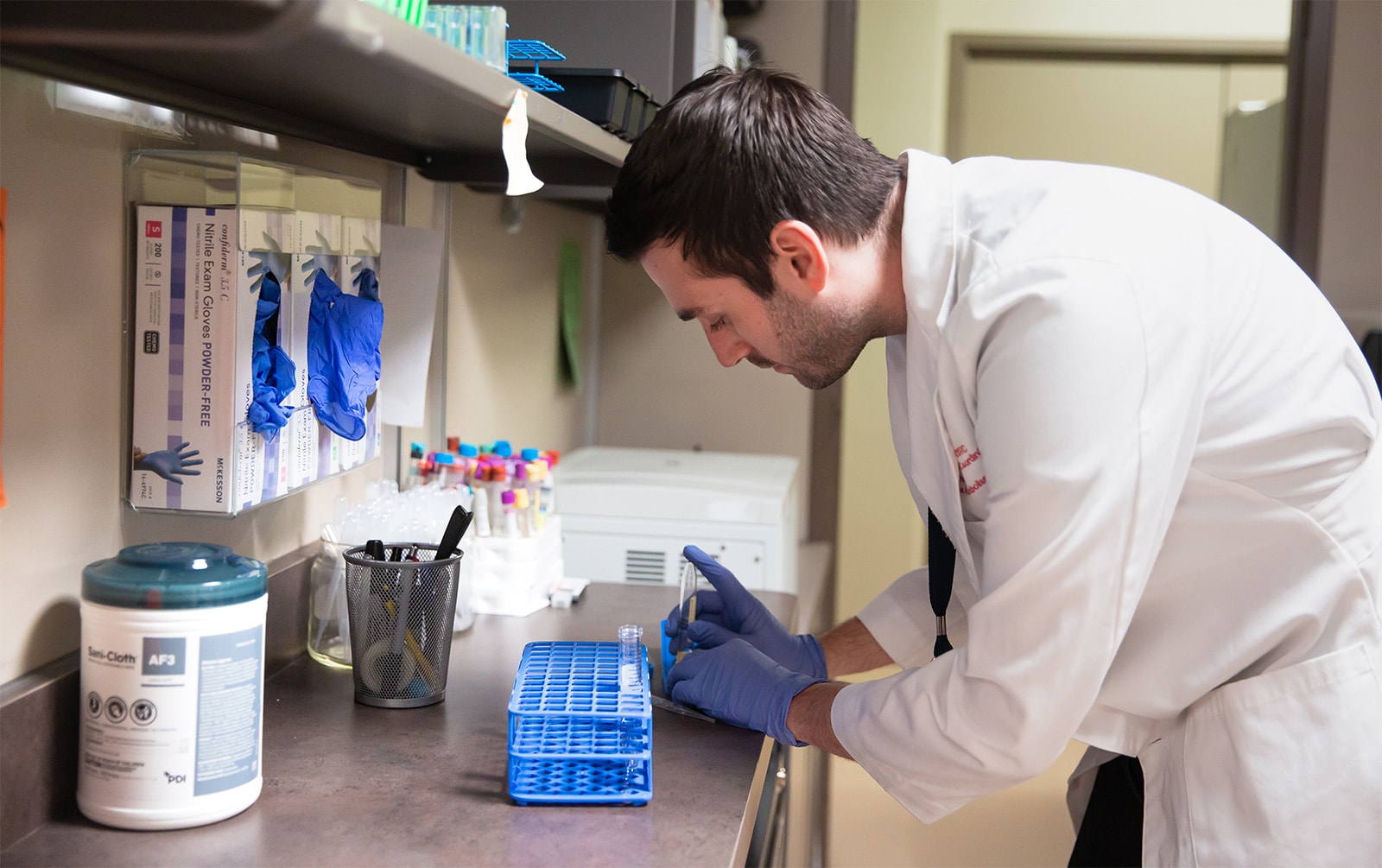 clinical research student works with vial