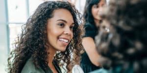 Female at event talking to people around her.