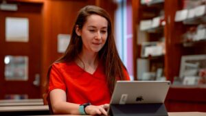 Woman healthcare professional typing on a computer.