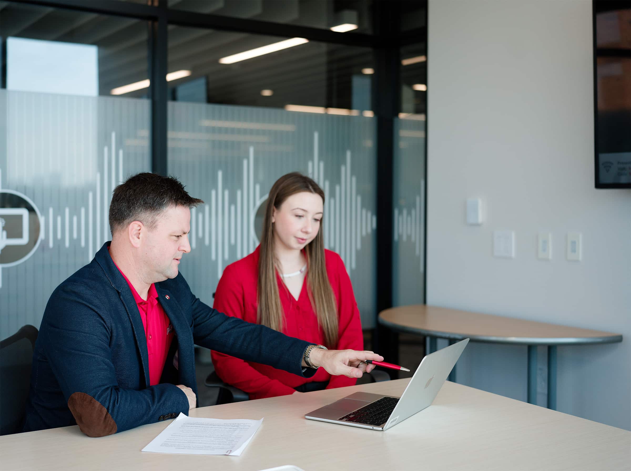 Master in the Study of Law students collaborate at a laptop.