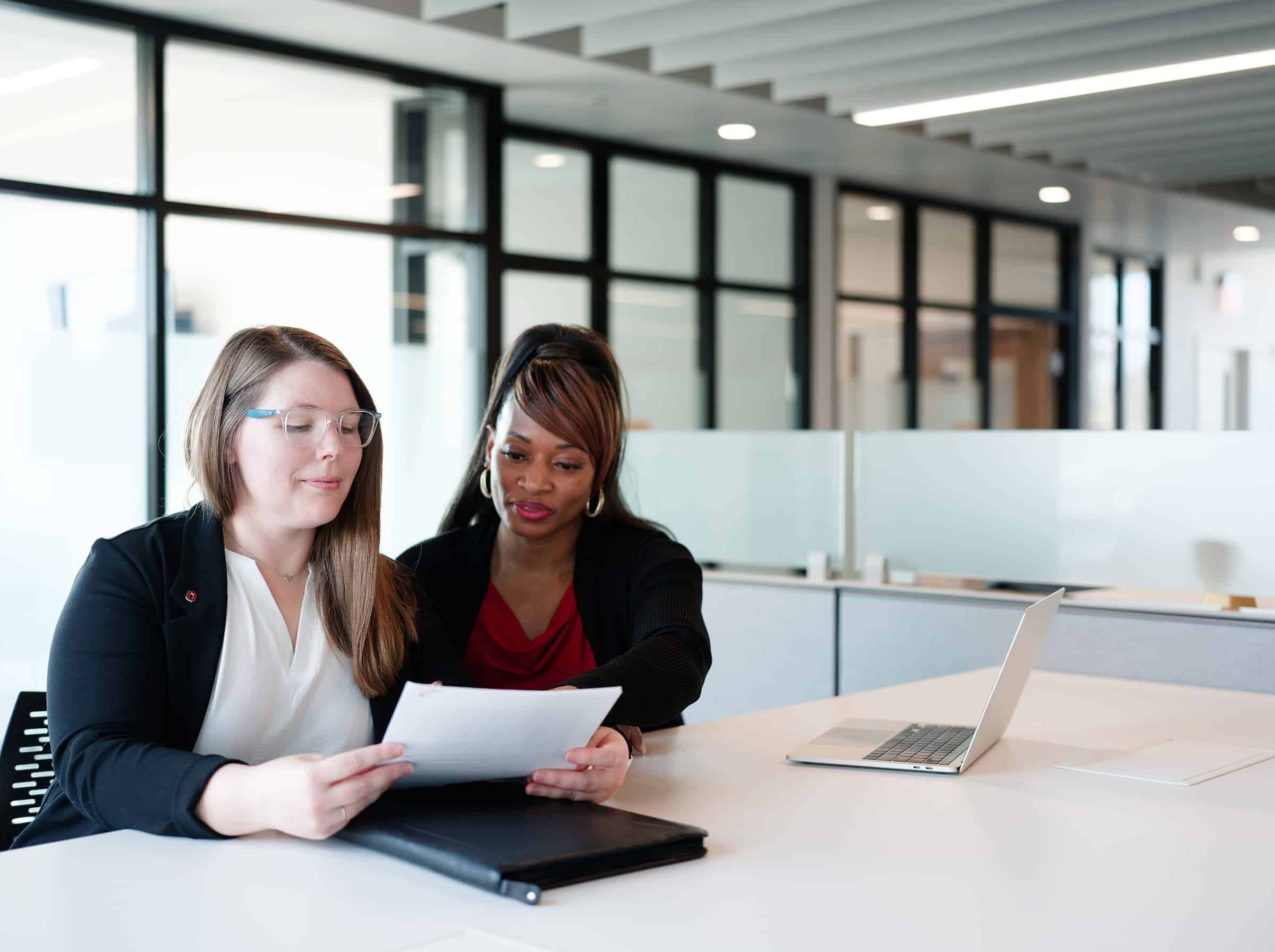 Graduates of the Moritz College of Law's online legal studies master's review legal documents together.