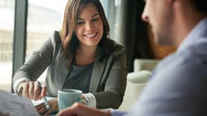 Female manager in a meeting discussing with colleague.