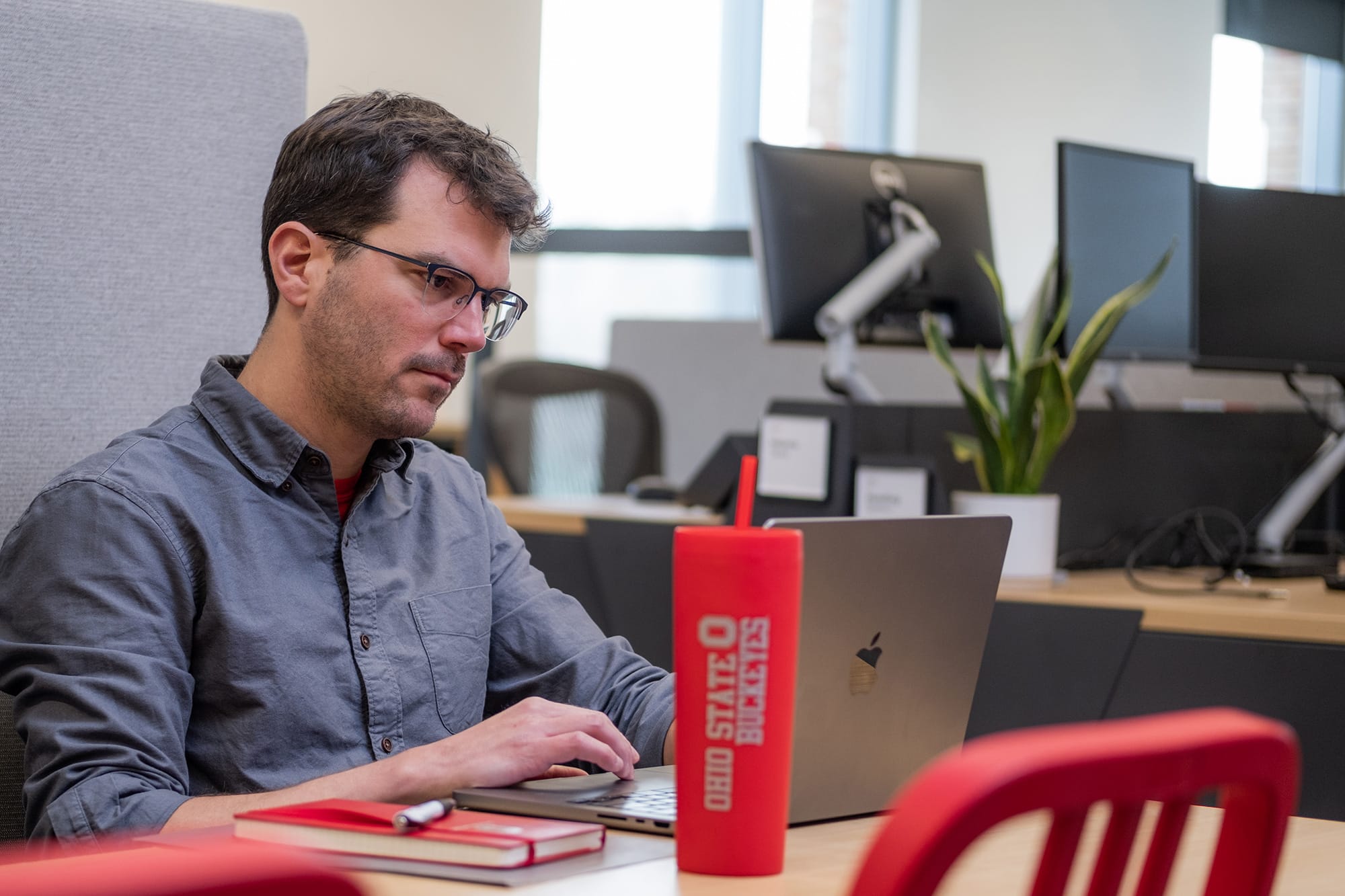 Adult learner uses laptop to study online at Ohio State.