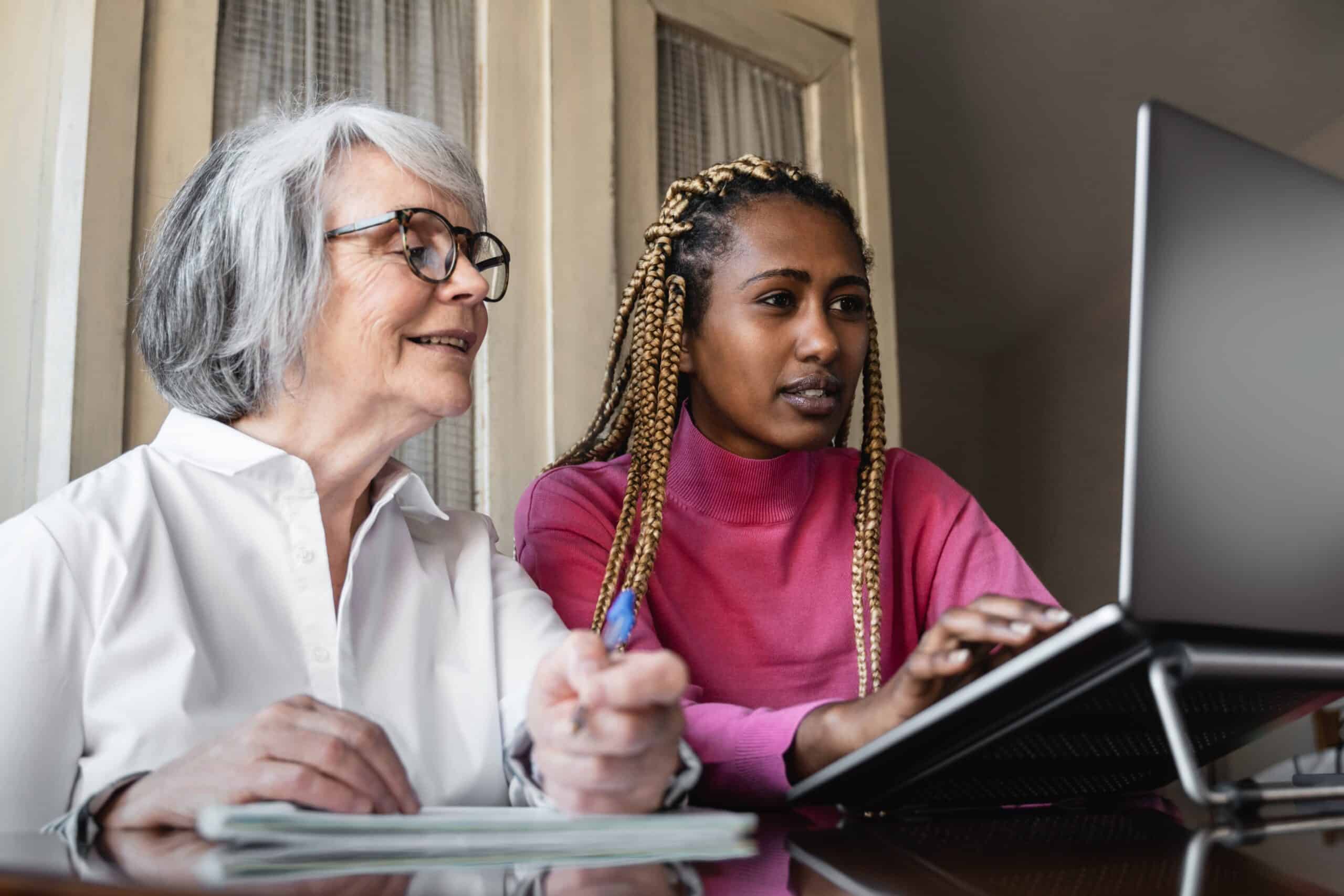 Social worker assisting patient with computer.