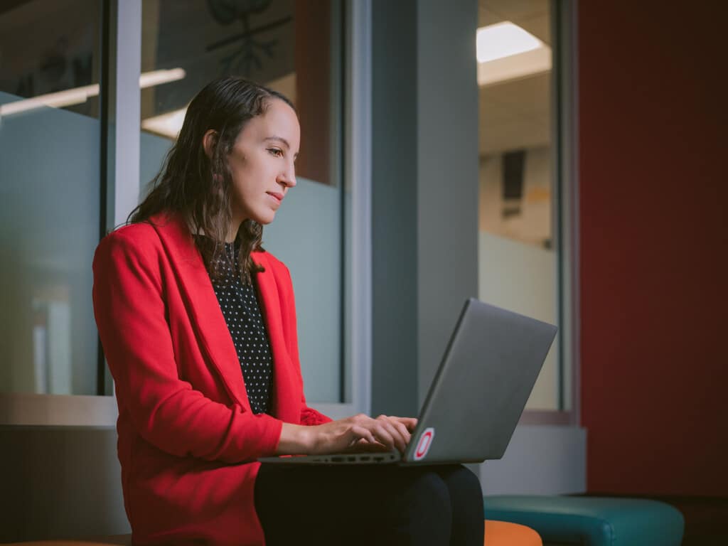 An Ohio State Online student working on a laptop