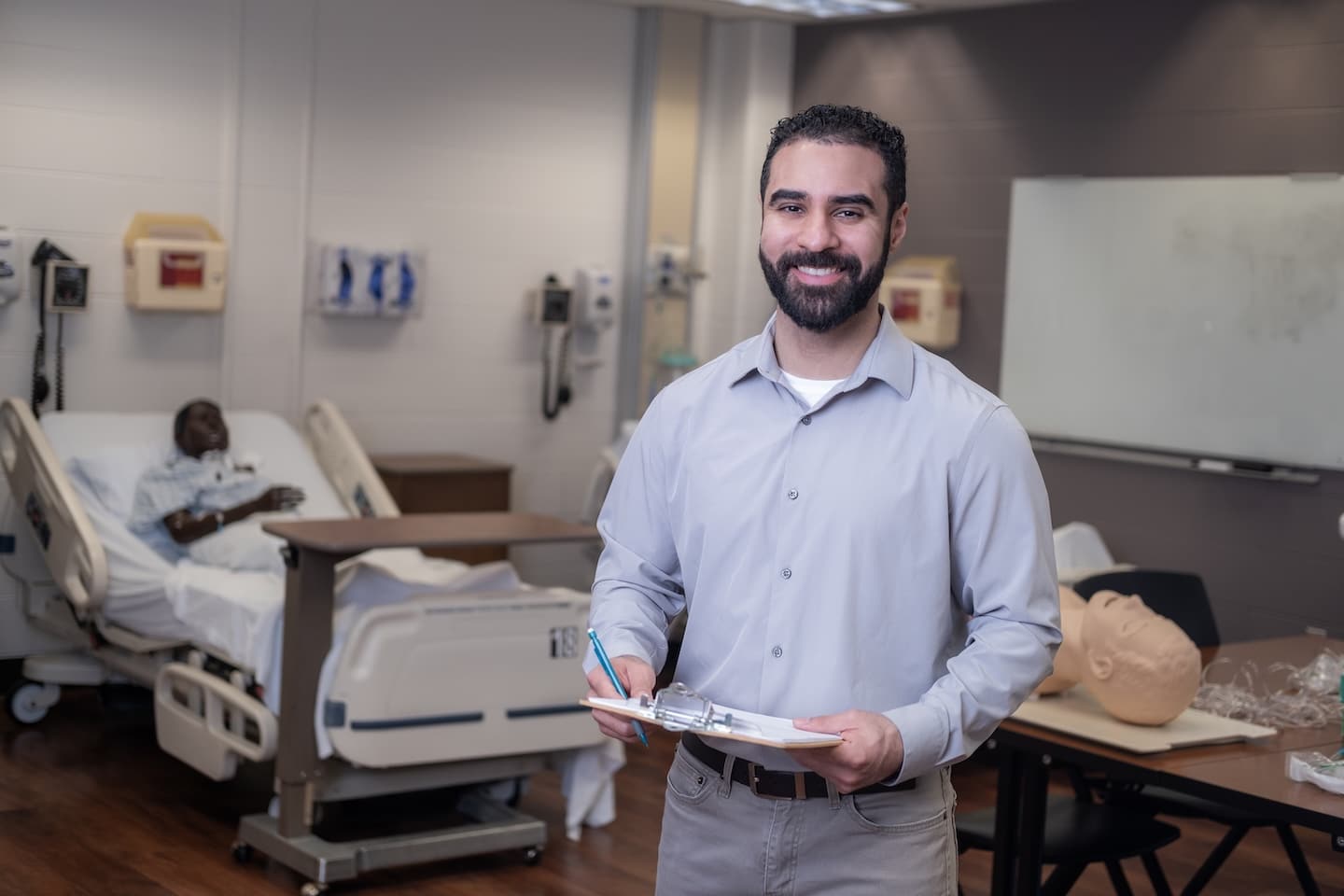 An Ohio State Master of Healthcare Innovation graduate stands in a healthcare setting.