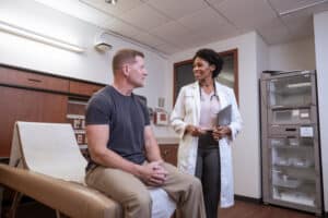 Female Adult-Gerontology Primary Care Nurse Practitioner with male patient