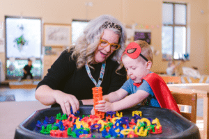 Behavior analyst working one‑on‑one with a child in a classroom