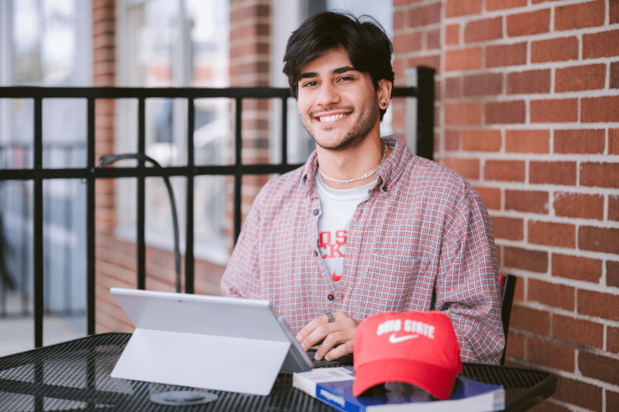 An Ohio State Online student working outside.
